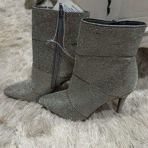 Size 7 metallic silver booties. Never worn